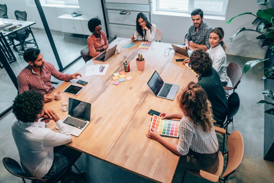 team at conference table using computers