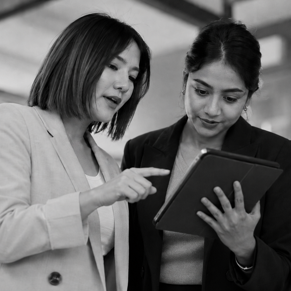 Two women reviewing information together on a tablet