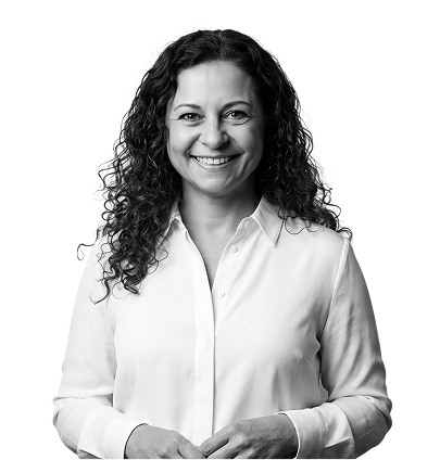 IncWorx consultant, Fanan, smiling in a white buttoned up blouse, hands together casually in front of her body.