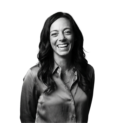 IncWorx consultant, Heidi, laughing casually in a grey blouse, arms behind her back.