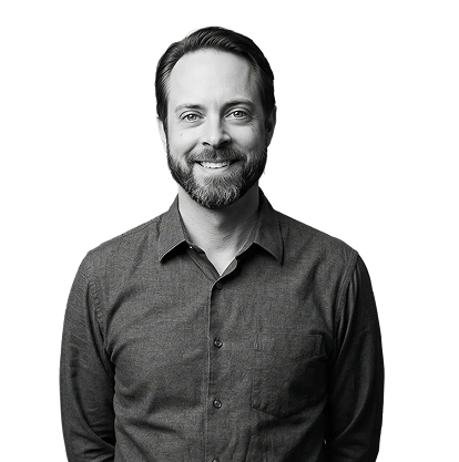 IncWorx consultant, Matt, smiling in a grey collared shirt, arms behind his back.