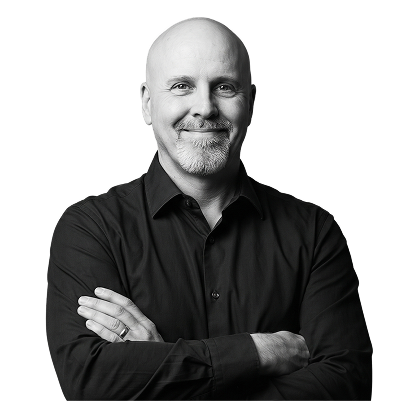 IncWorx consultant, Jason, smiling, arms crossed, in a black collared shirt.