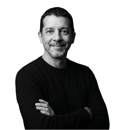 IncWorx Consultant, Chris, smiling in black sweater, arms crossed casually.