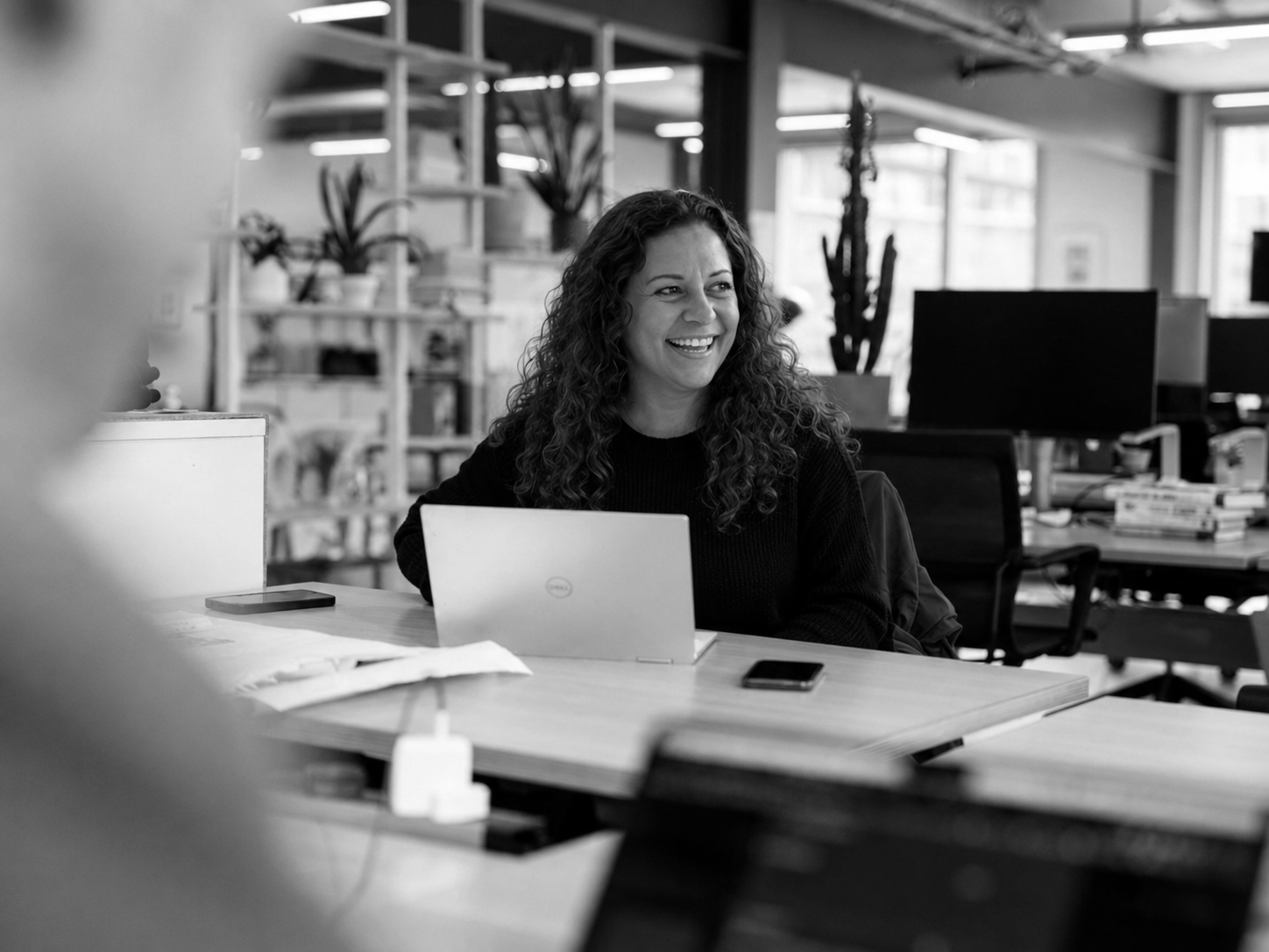 Professional at a laptop in a modern office, representing Microsoft partner careers, consulting roles, and collaborative work.