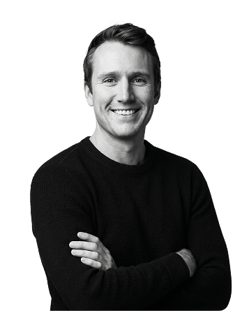IncWorx consultant, McCaslin, smiling in black long-sleeve shirt, arms crossed casually.