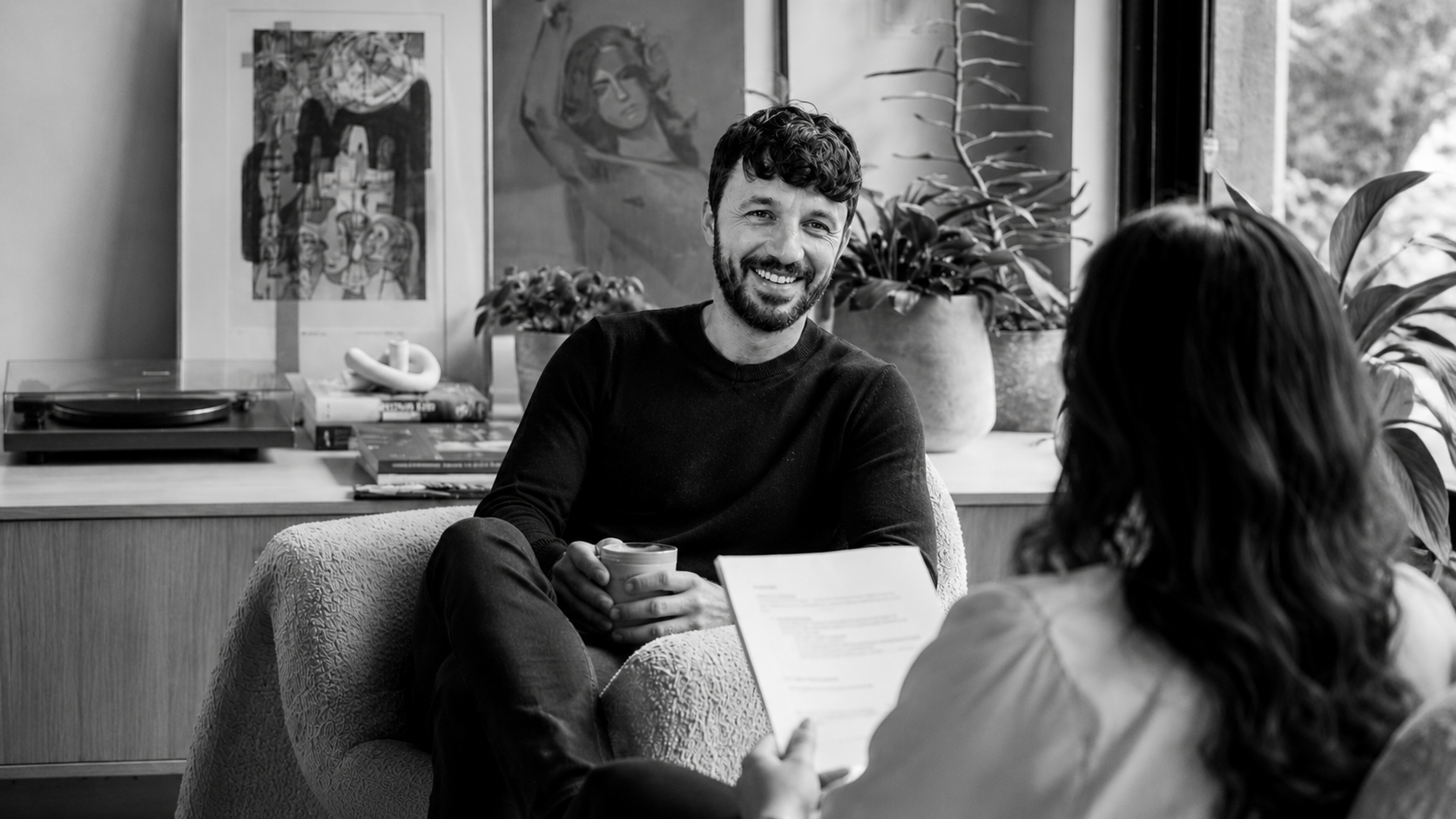 Technology consultant meets with a colleague in a modern office, representing Microsoft consulting, collaboration, and client-focused strategy.